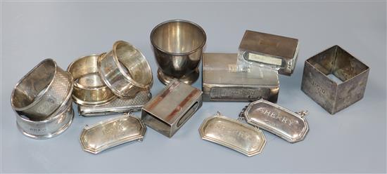 Four assorted silver match sleeves, five assorted silver napkin rings, three silver modern wine labels and an egg cup